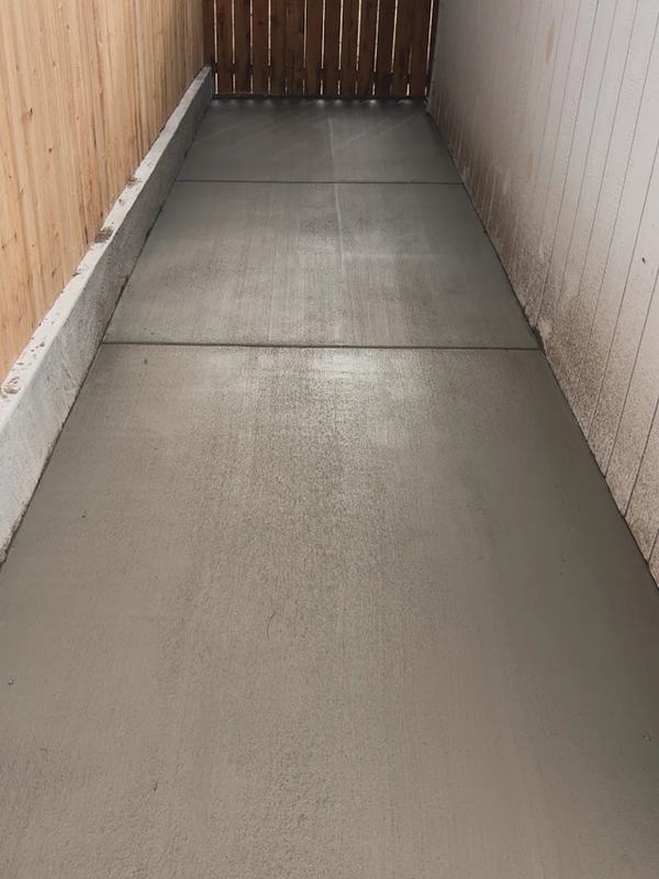 Finished concrete floor inside a narrow wood-frame shop building